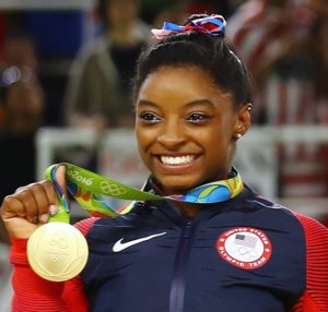 Simone Biles poses with her gold medal after USA won gold the women's team final in Rio de Janeiro on August 9, 2016. Photo courtesy of REUTERS/Mike Blake *Editors: This photo may only be republished with RNS-OLYMPICS-BILES, originally transmitted on August 10, 2016.